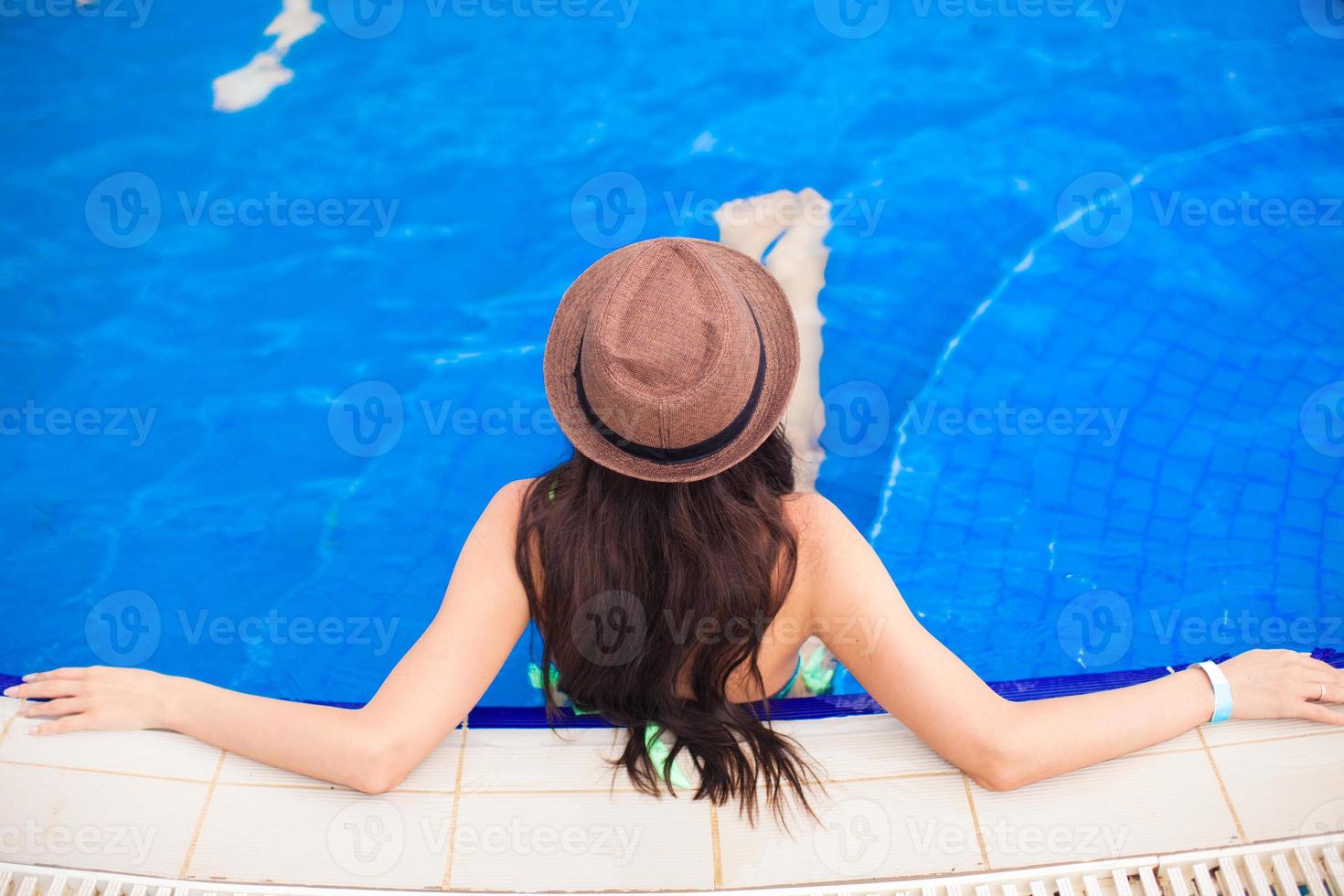 Top view of a young woman wearing hat in the pool photo