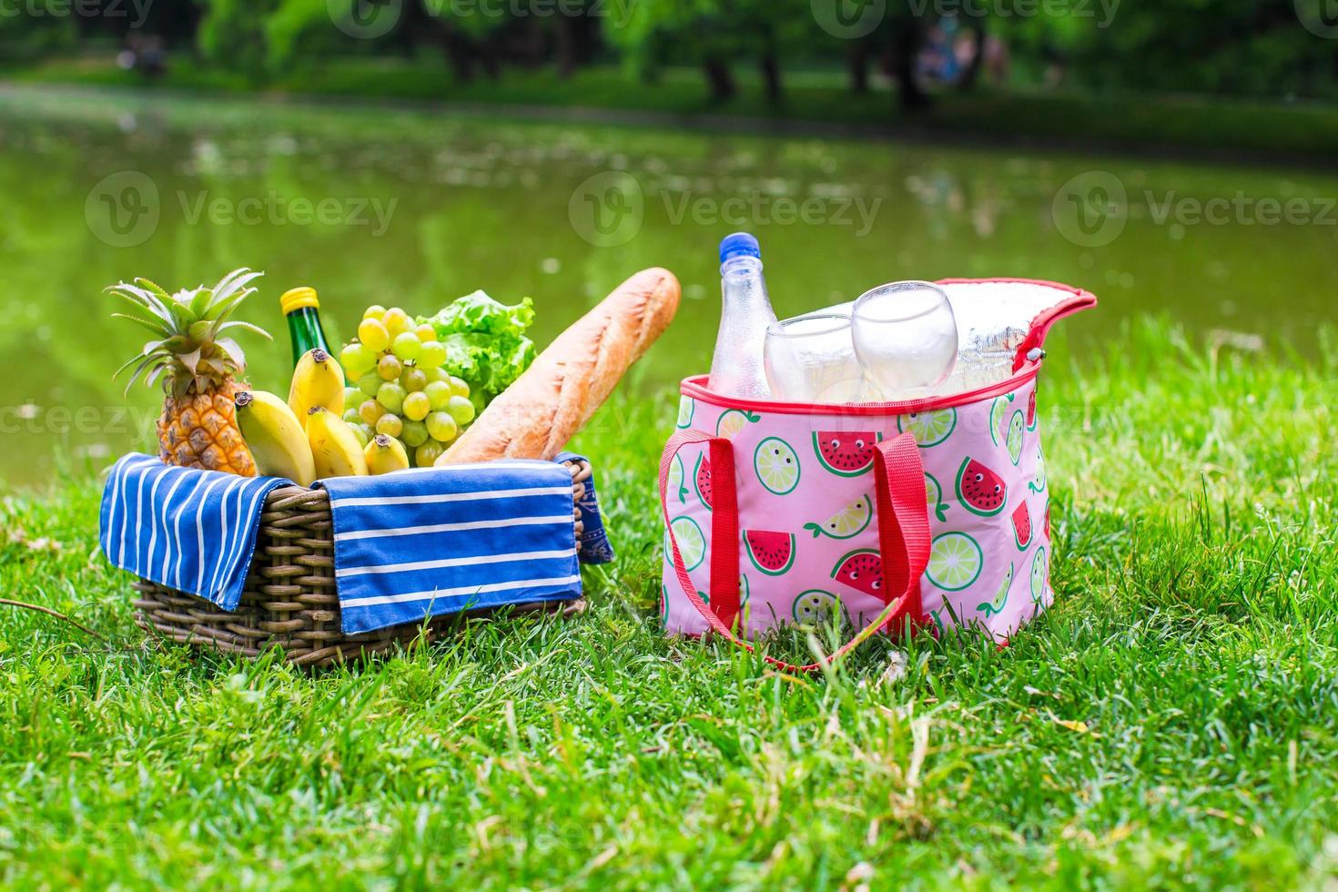 Picnic setting with white wine, pears, fruits, bread photo