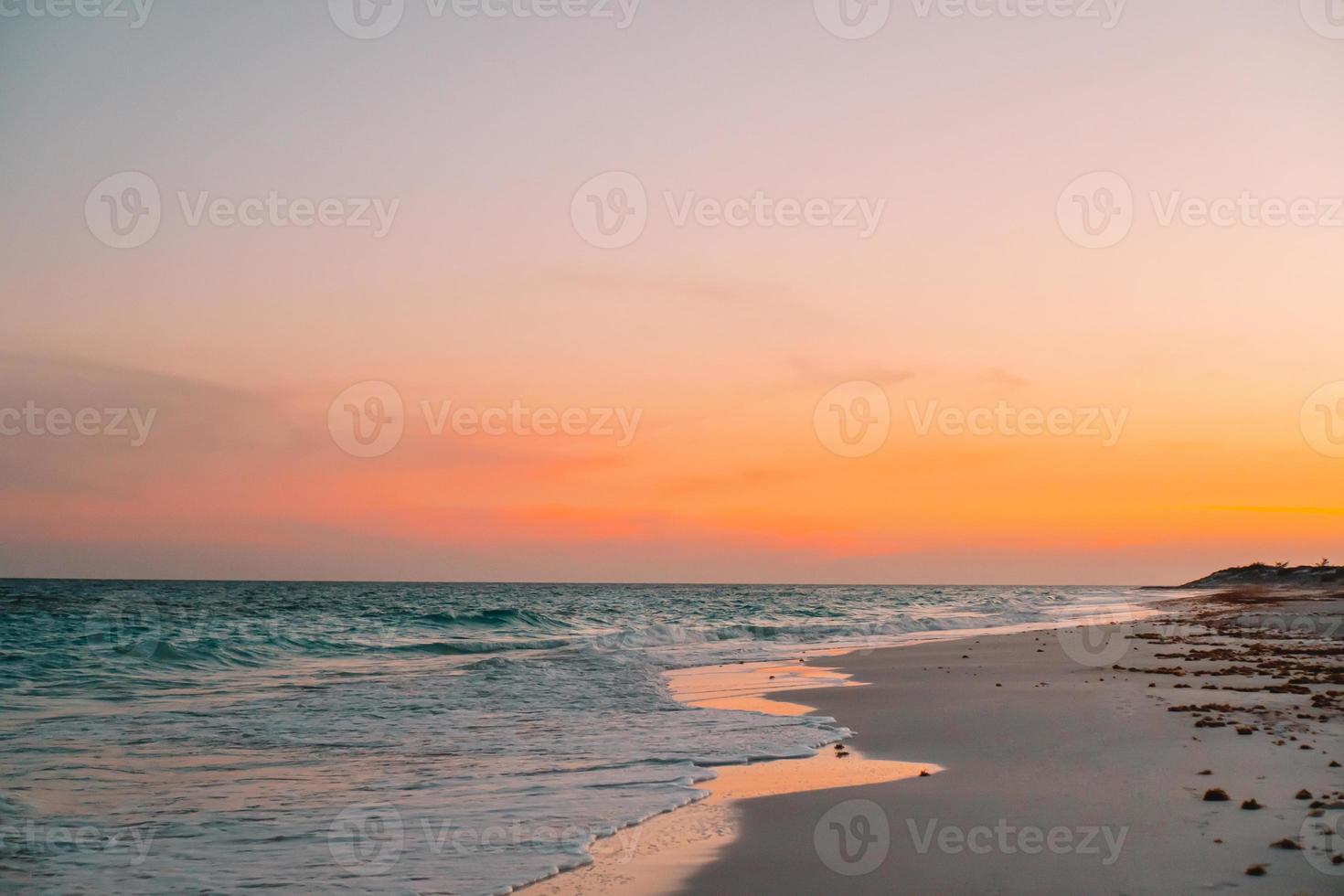 Amazing beautiful sunset on an exotic caribbean beach photo