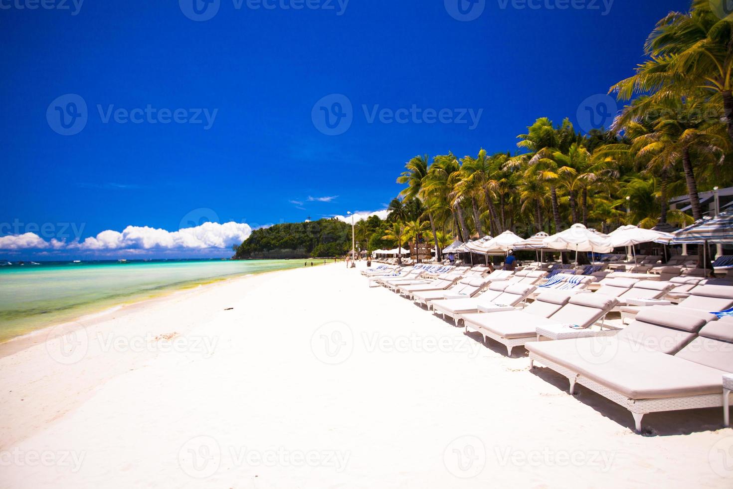 Tropical white sunny beach in beautiful exotic resort photo