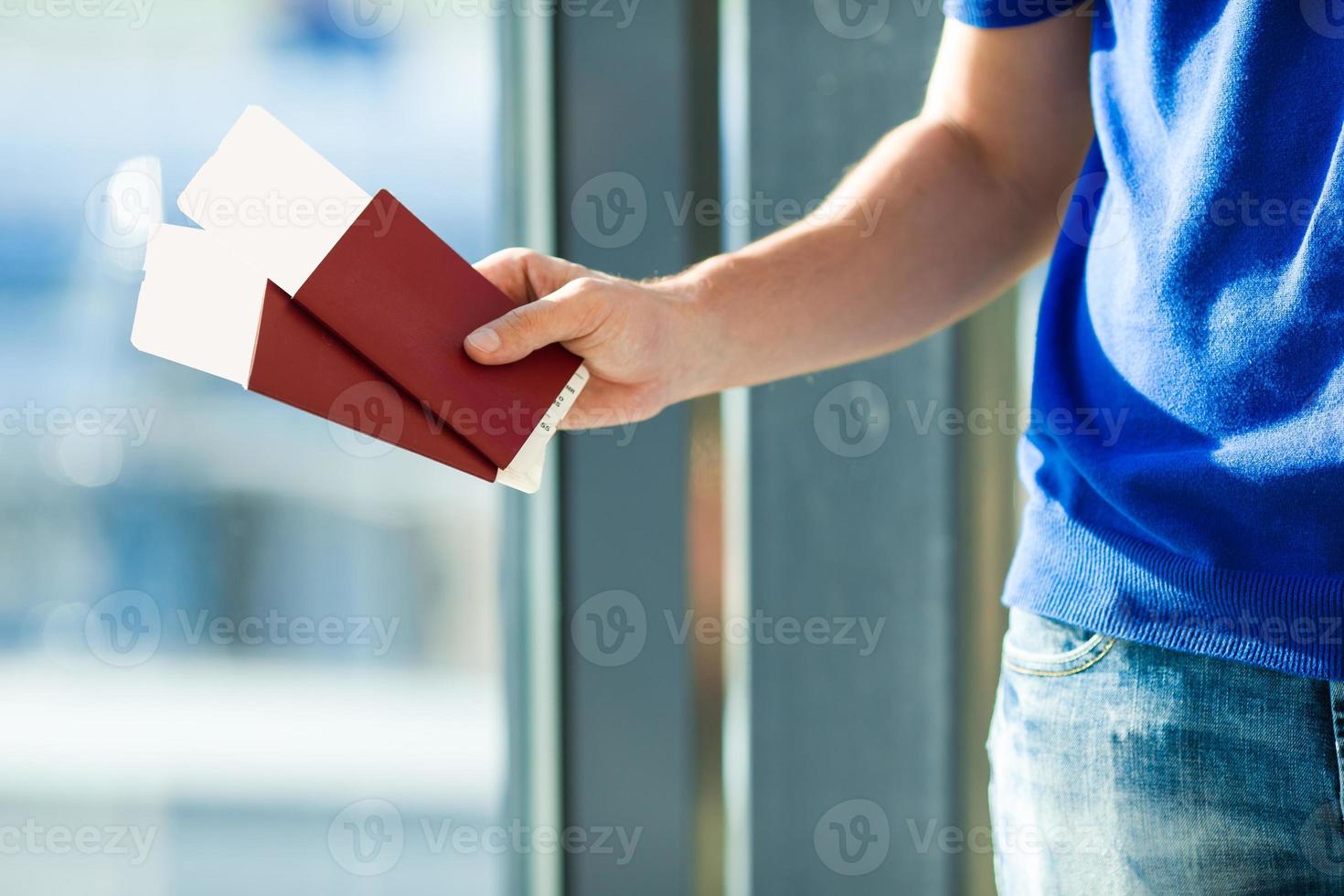 Closeup passports and boarding pass at airport indoor background airplane photo