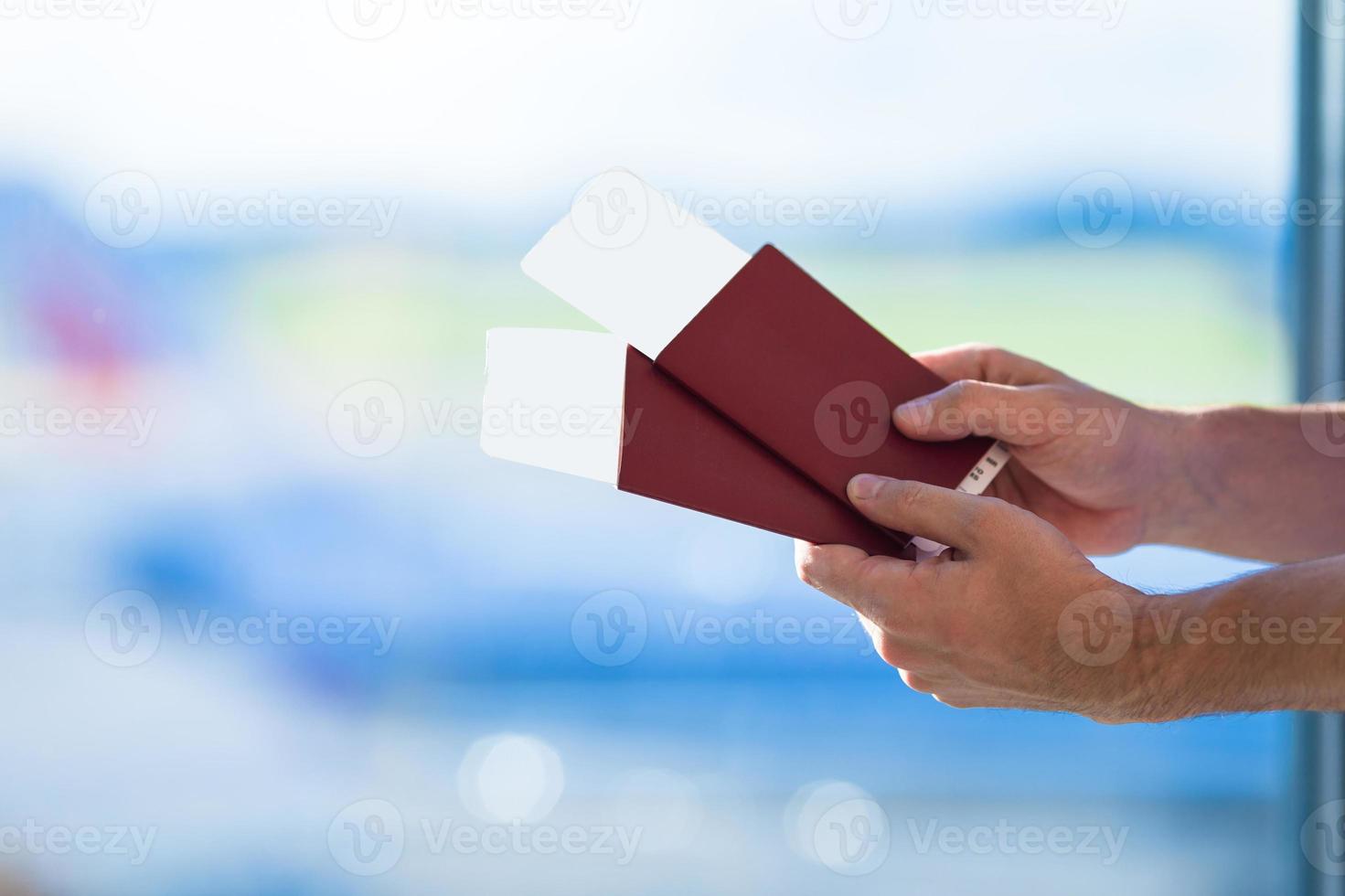 Closeup passports and boarding pass at airport indoor background airplane photo