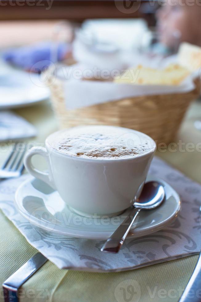 capuchino delicioso y sabroso para el desayuno en el café foto