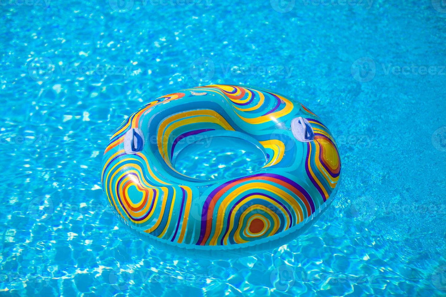 Colorful pool float in blue swimming basin photo