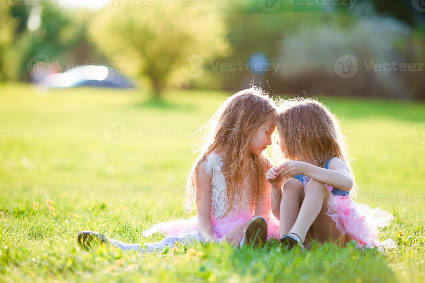 Adorable little girls on spring day outdoors photo