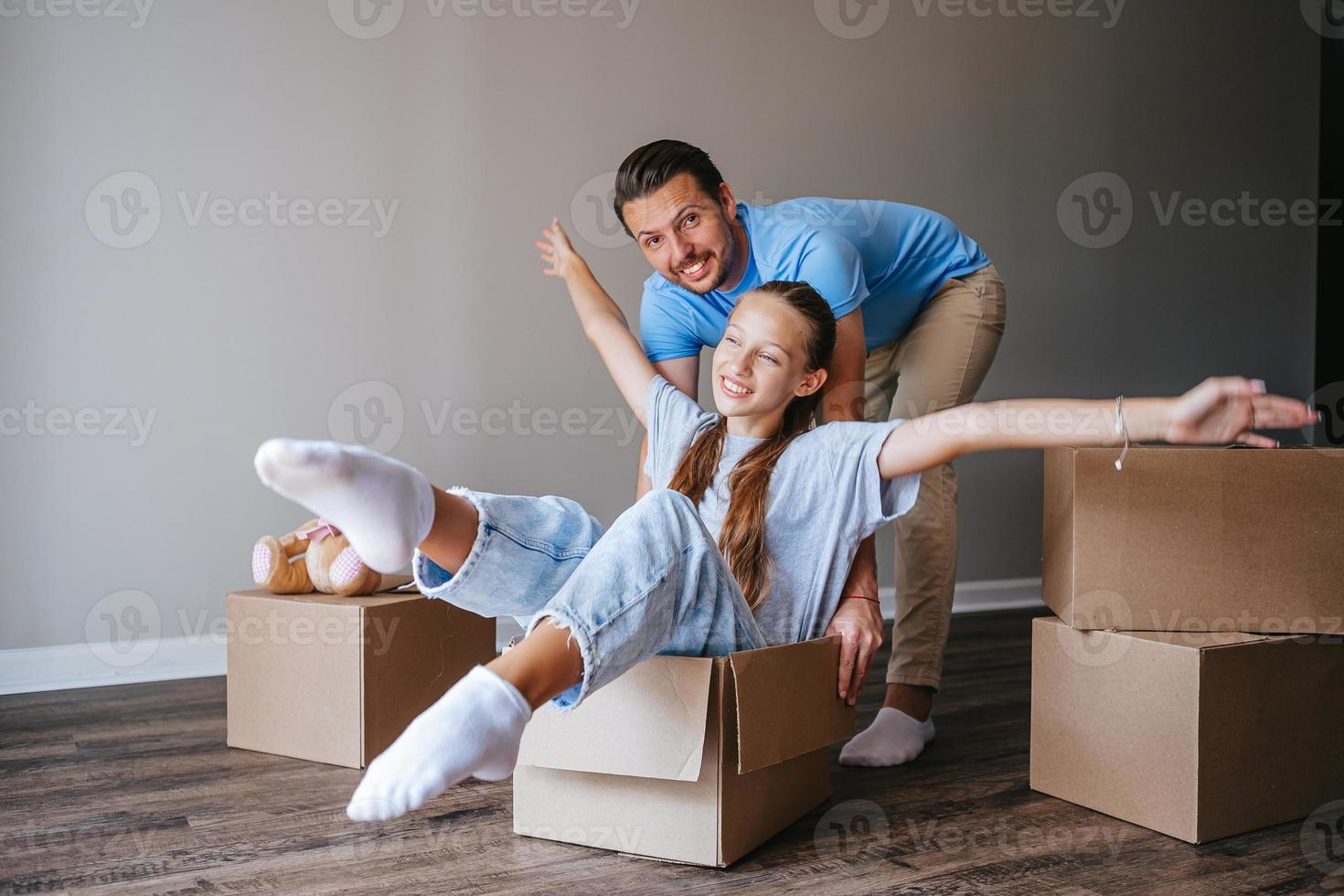 Family have fun on moving day in their new home photo