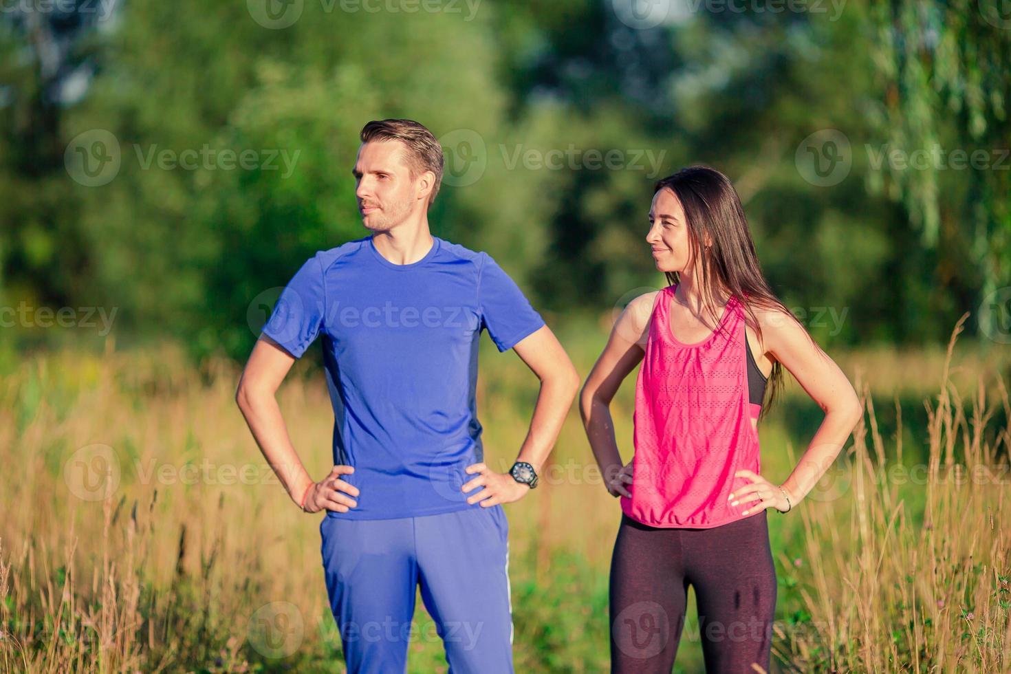 Active sportive couple running in park. Health and fitness. photo