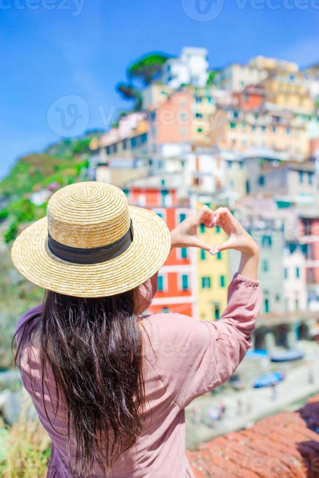 Beautiful woman with amazing view of the italian village in old street in Cinque Terre, Italy photo