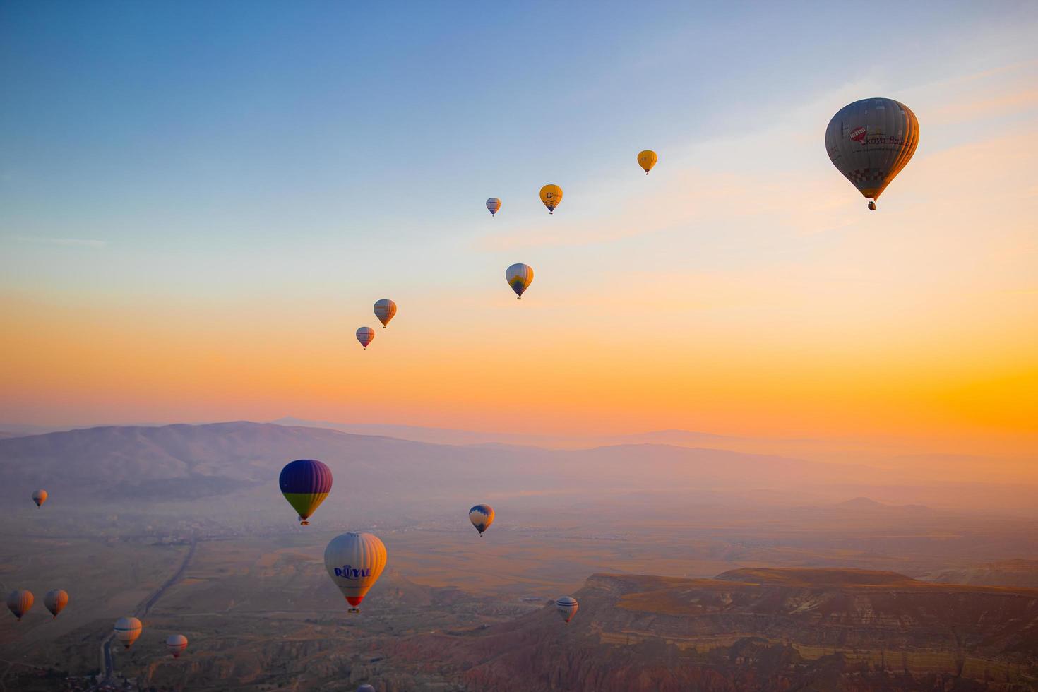 GOREME, TURKEY - SEPTEMBER 18. 2021 Bright hot air balloons in sky of Cappadocia, Turkey photo