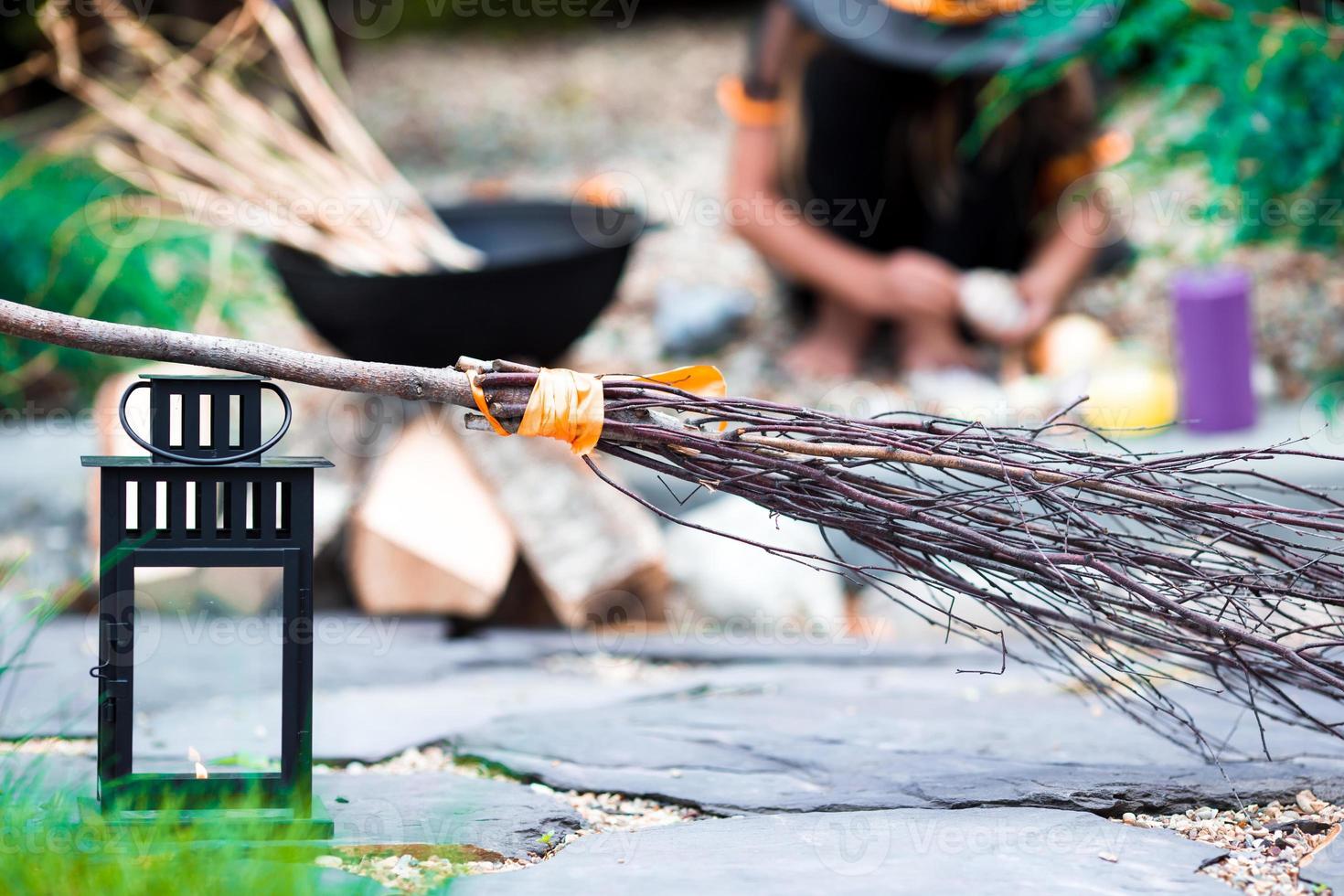 Halloween accessories hat, broom, candle, garlic and flashlights photo