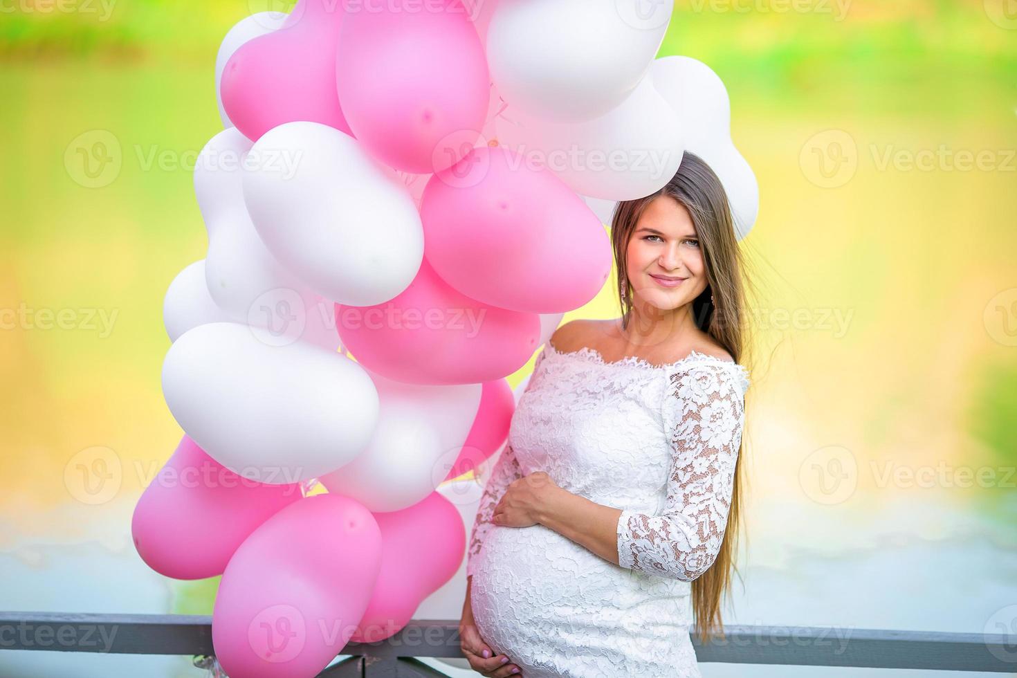 Pregnant woman in outdoor park, warm weather photo