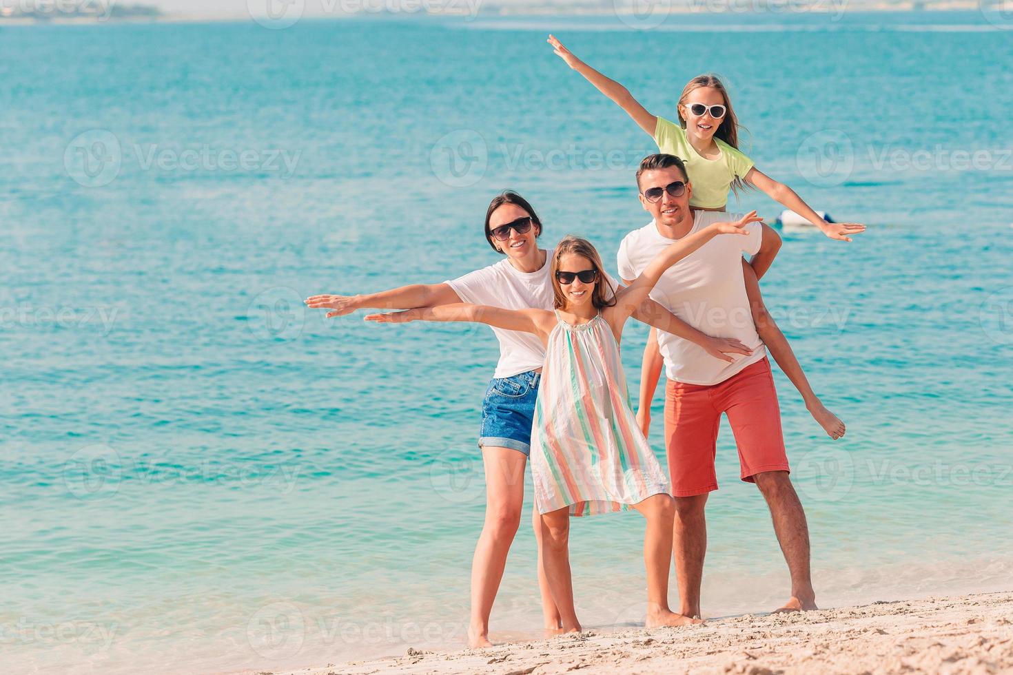 Photo of happy family having fun on the beach. Summer Lifestyle