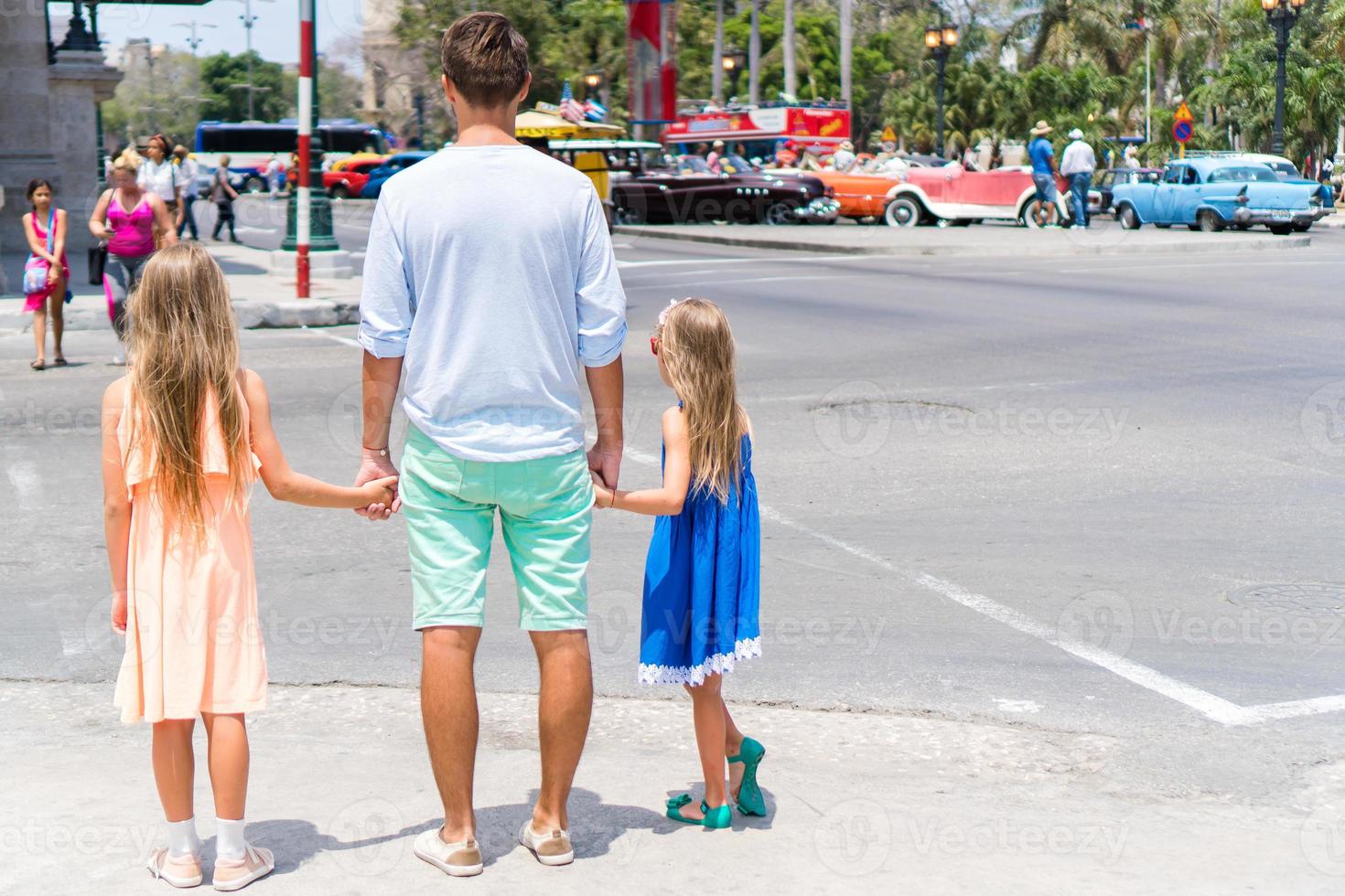 Family of dad and kids in popular area in Havana, Cuba. Family travel on the Caribbean islands photo