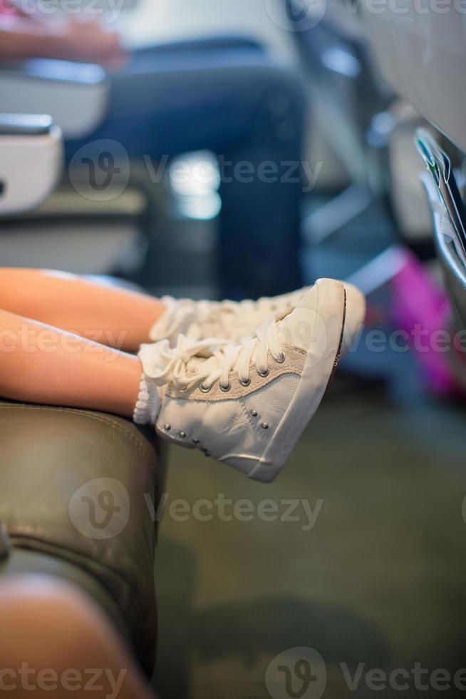 Baby feet on seat in the aircraft photo