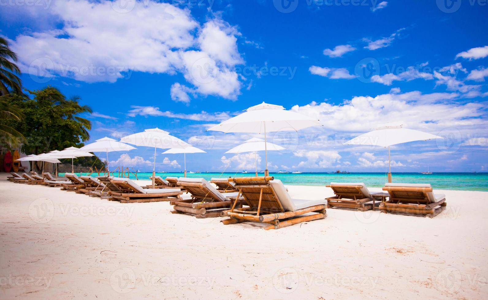 Beach wooden chairs for vacations on tropical beach photo