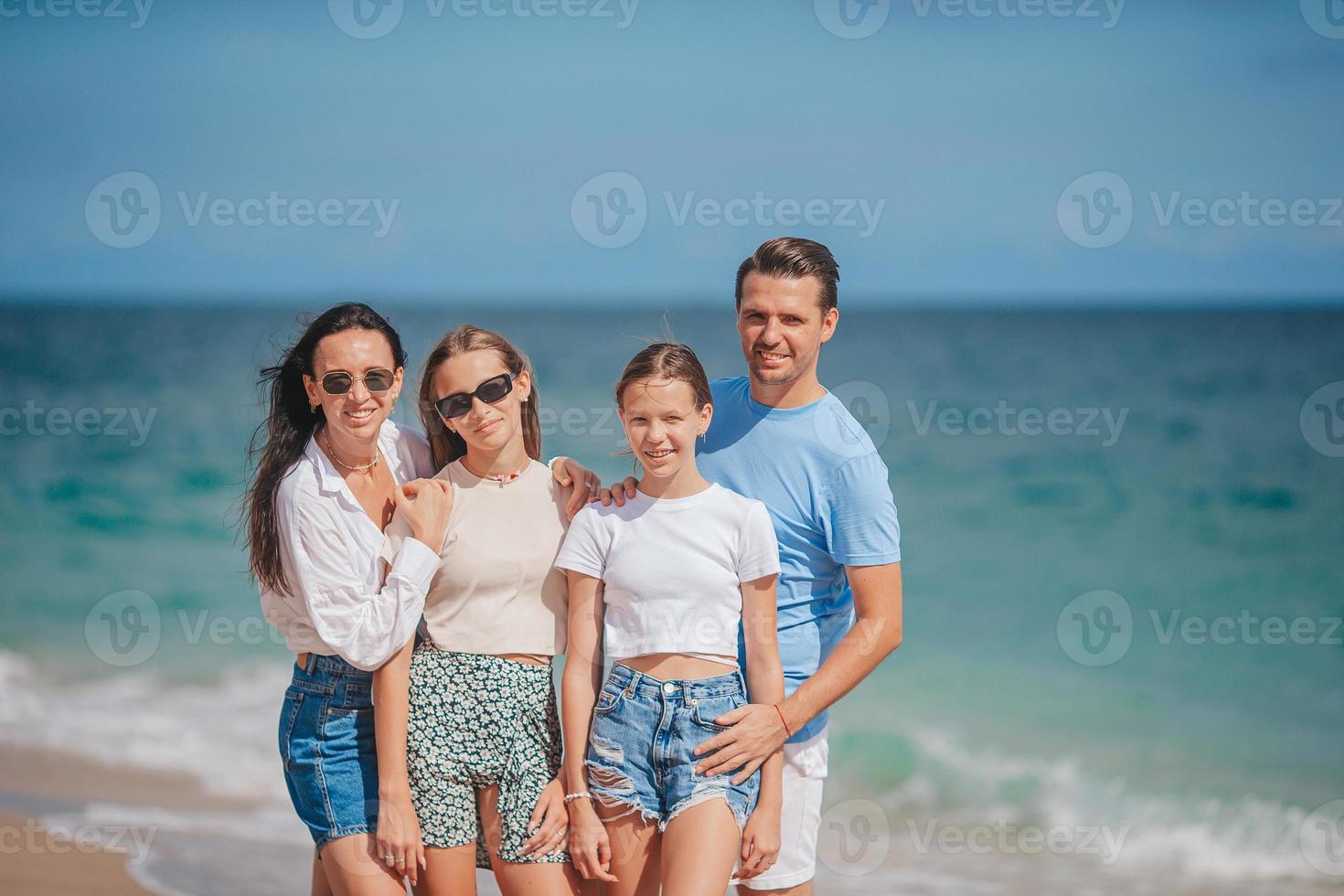 Happy family on the beach during summer vacation photo