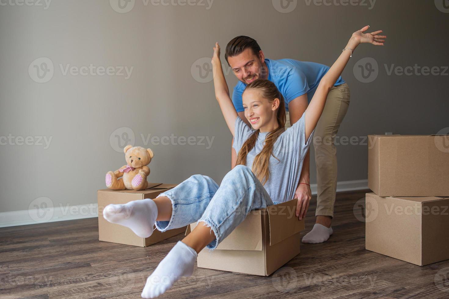 Happy father with daughter have fun in their new home. Family enjoy their moving day photo