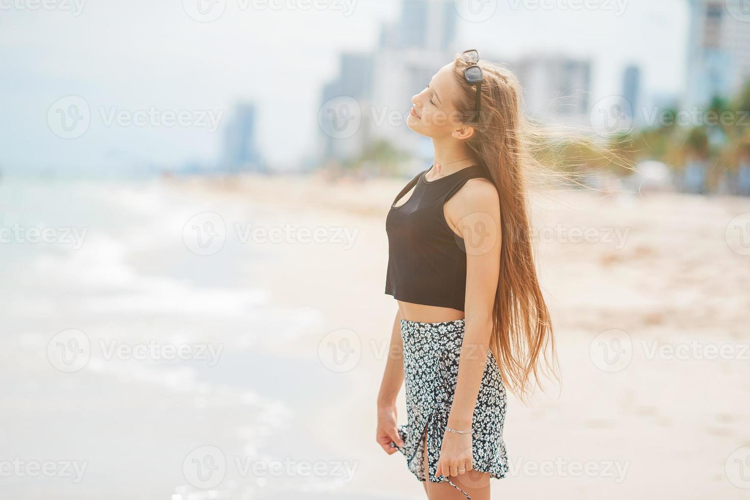 Happy young girl enjoy tropical beach vacation photo