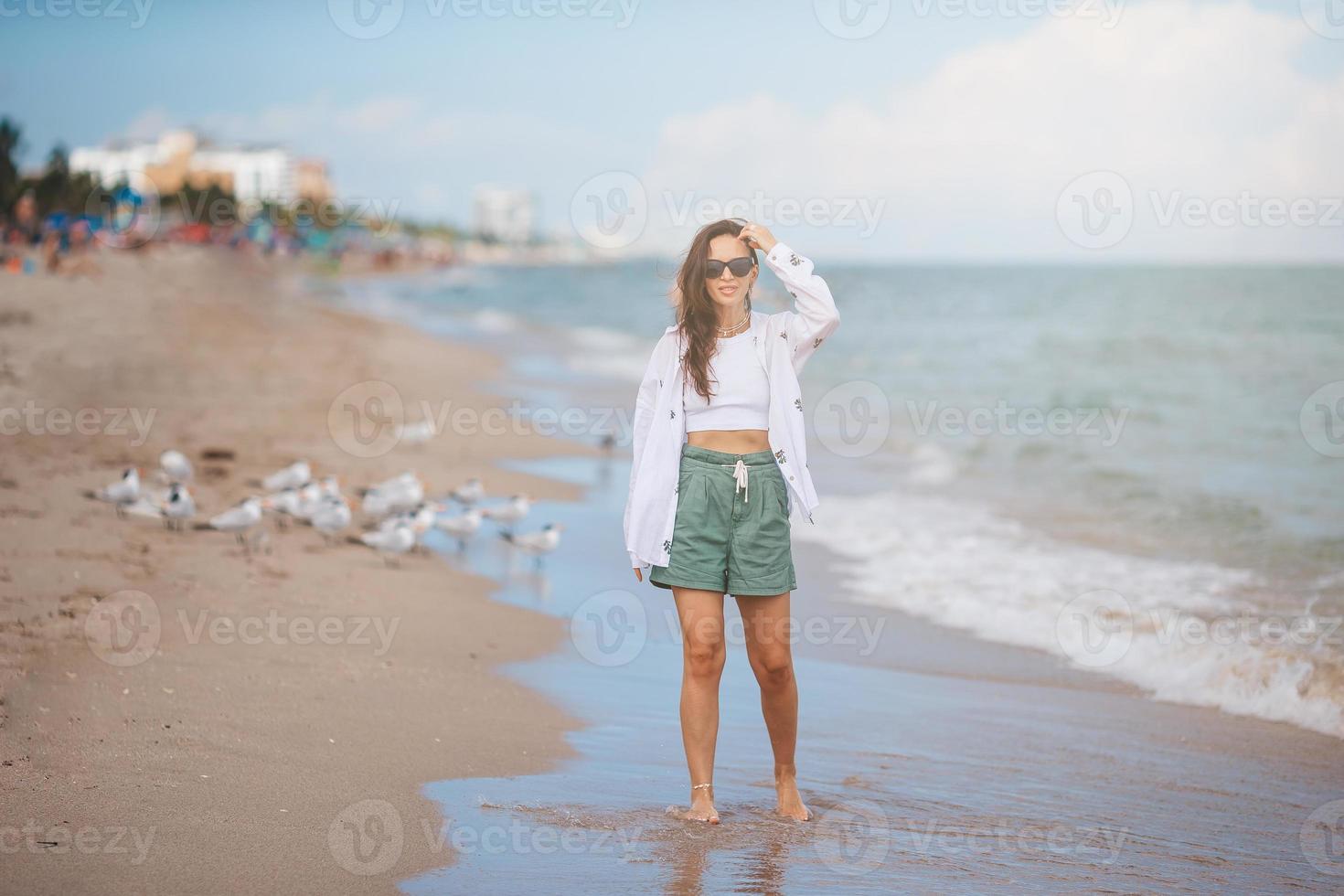 Young happy woman on the beach. photo