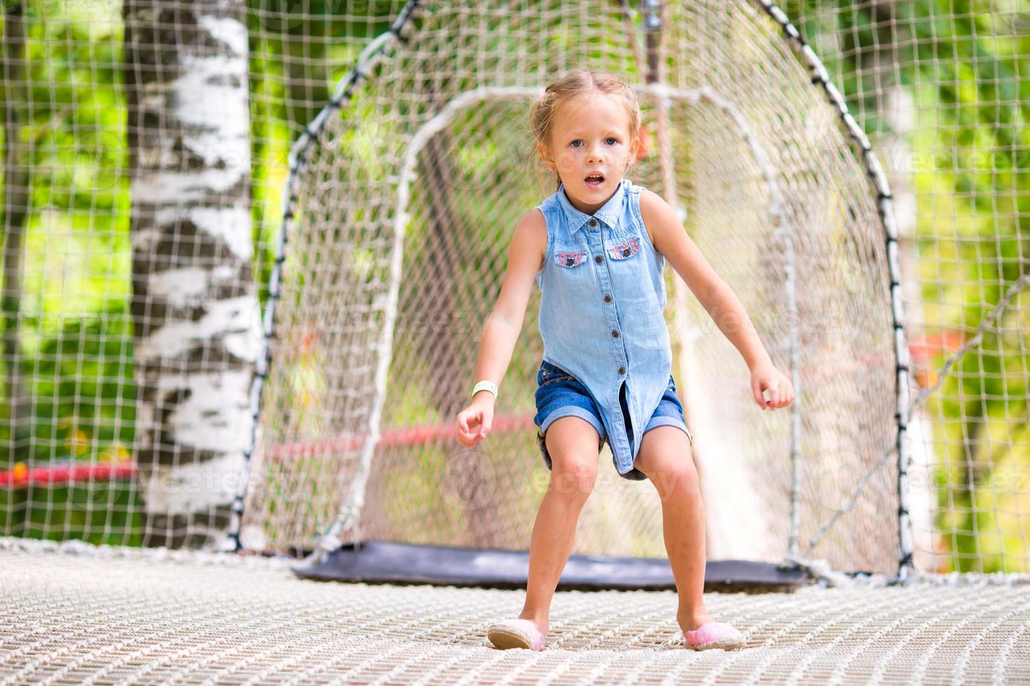 Little cute girl in summer park outdoors photo
