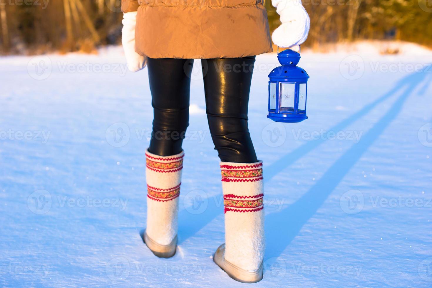 Closeup of beautiful vintage blue Christmas lantern on the snow photo