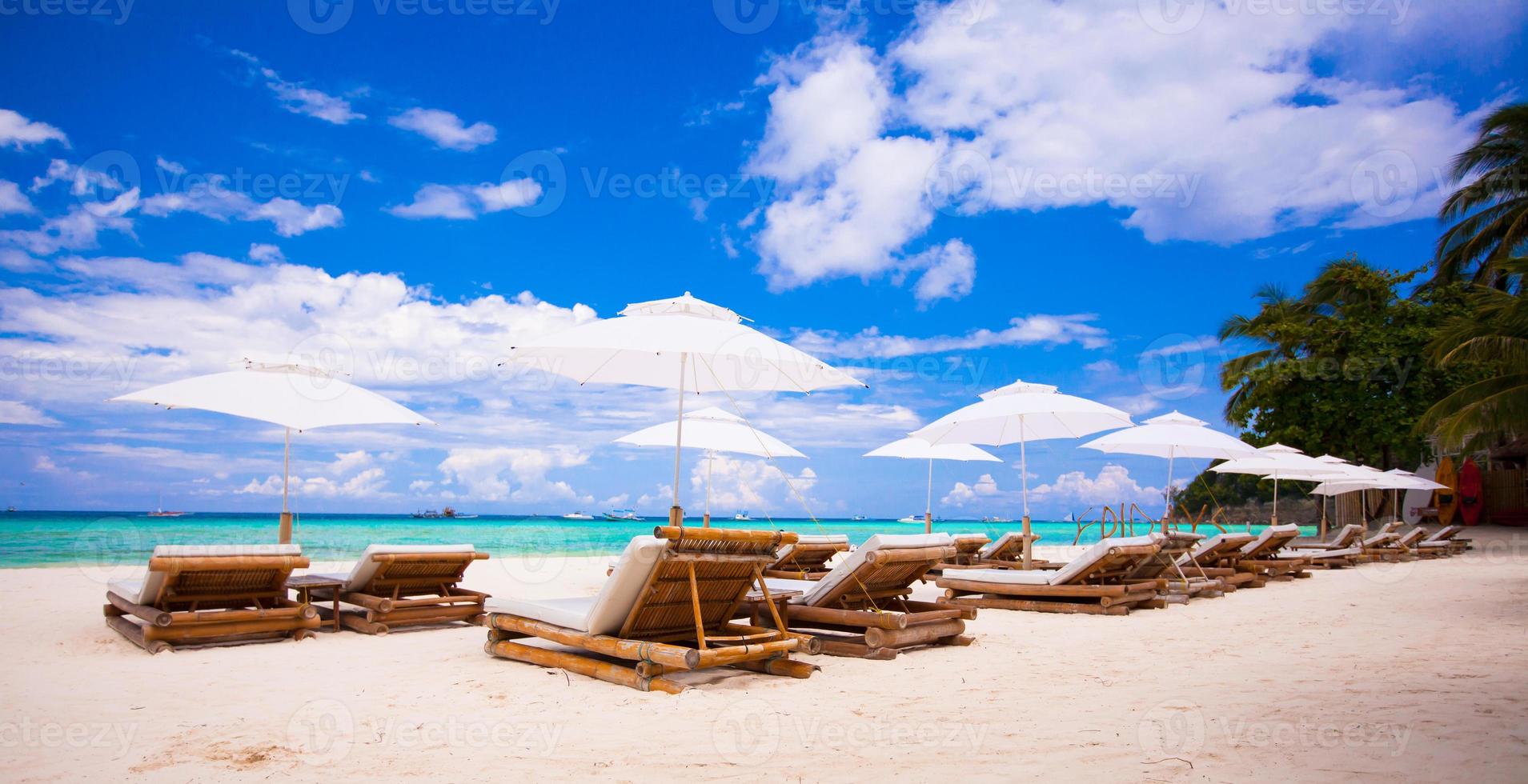 Beach wooden chairs for vacations on tropical beach photo