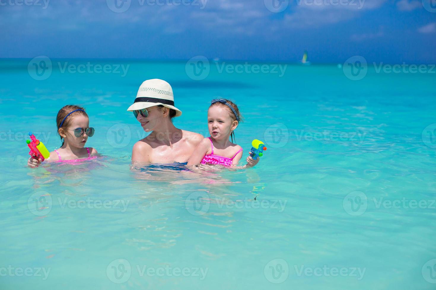 Happy family at tropical beach having fun photo