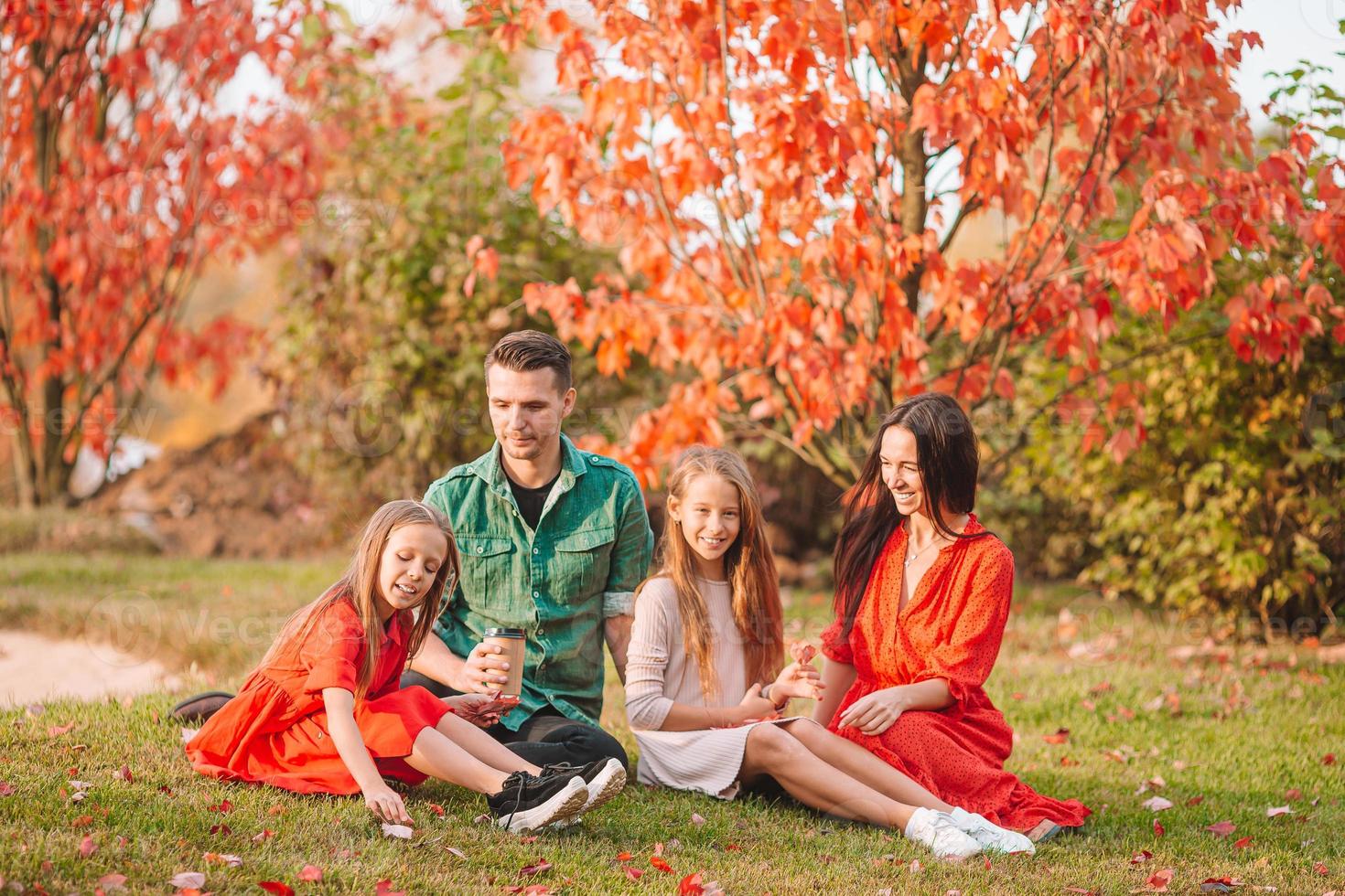 Portrait of happy family of four in autumn photo