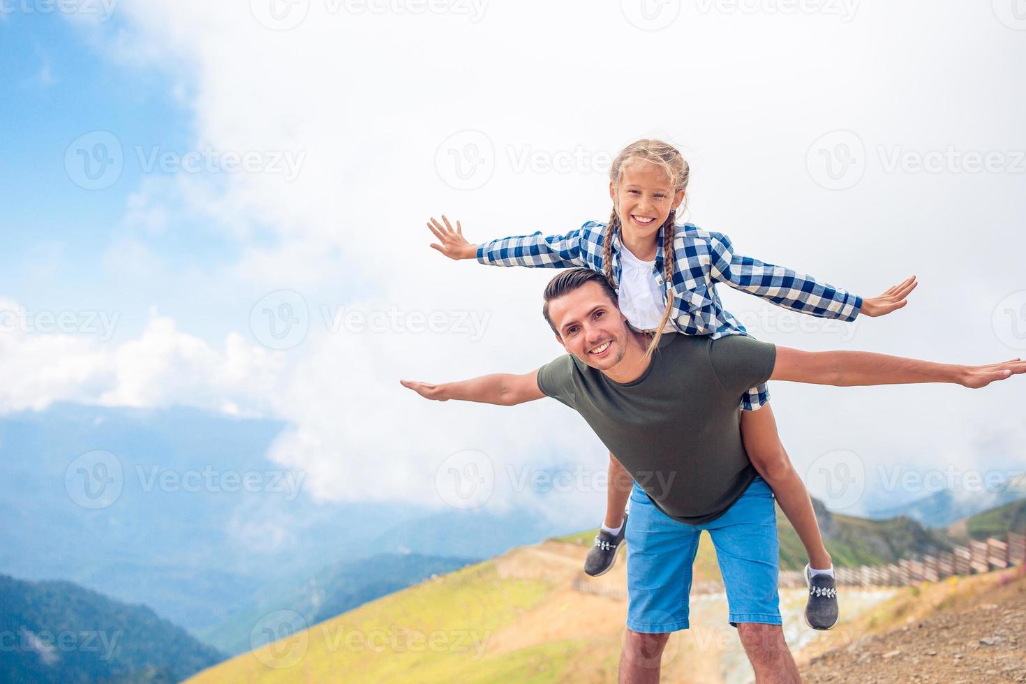 Beautiful happy family in mountains in the background of fog photo