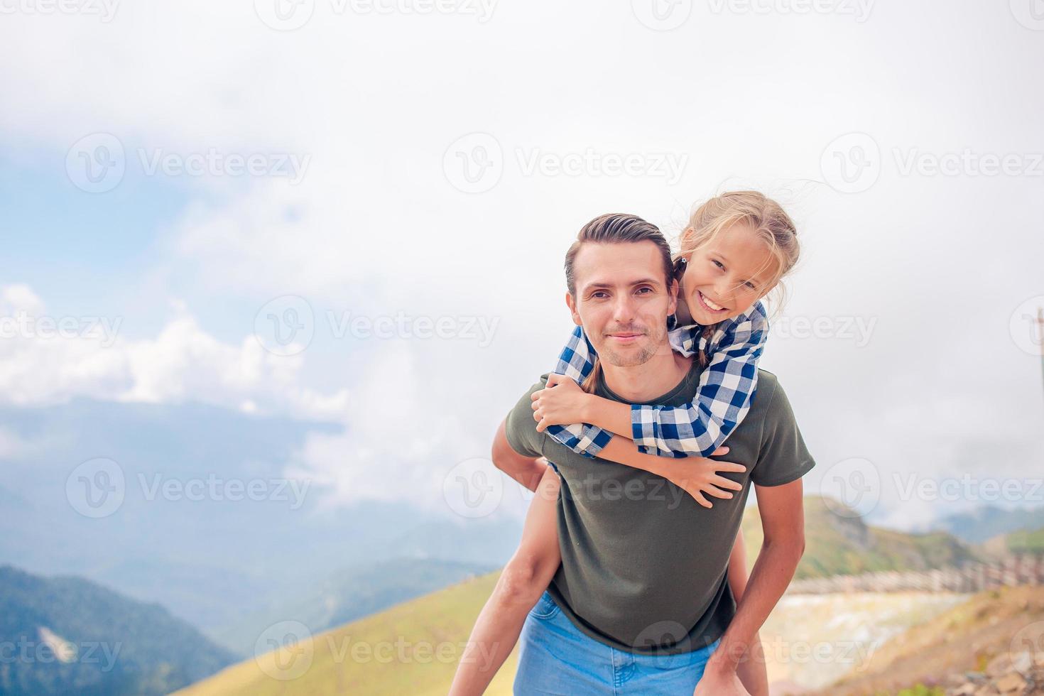 Beautiful happy family in mountains in the background of fog photo