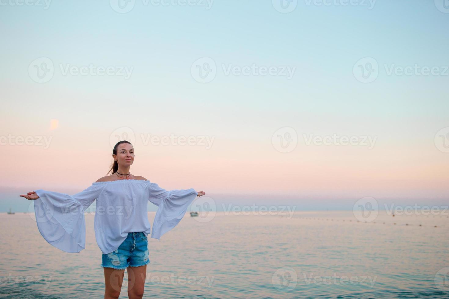 Young woman enjoying vacation on the beach in Europe photo