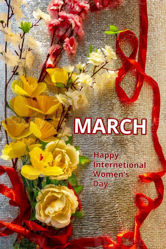 Figure 8 made of ribbon and artificial flowers for International Women's Day celebration on silver background with space for text photo