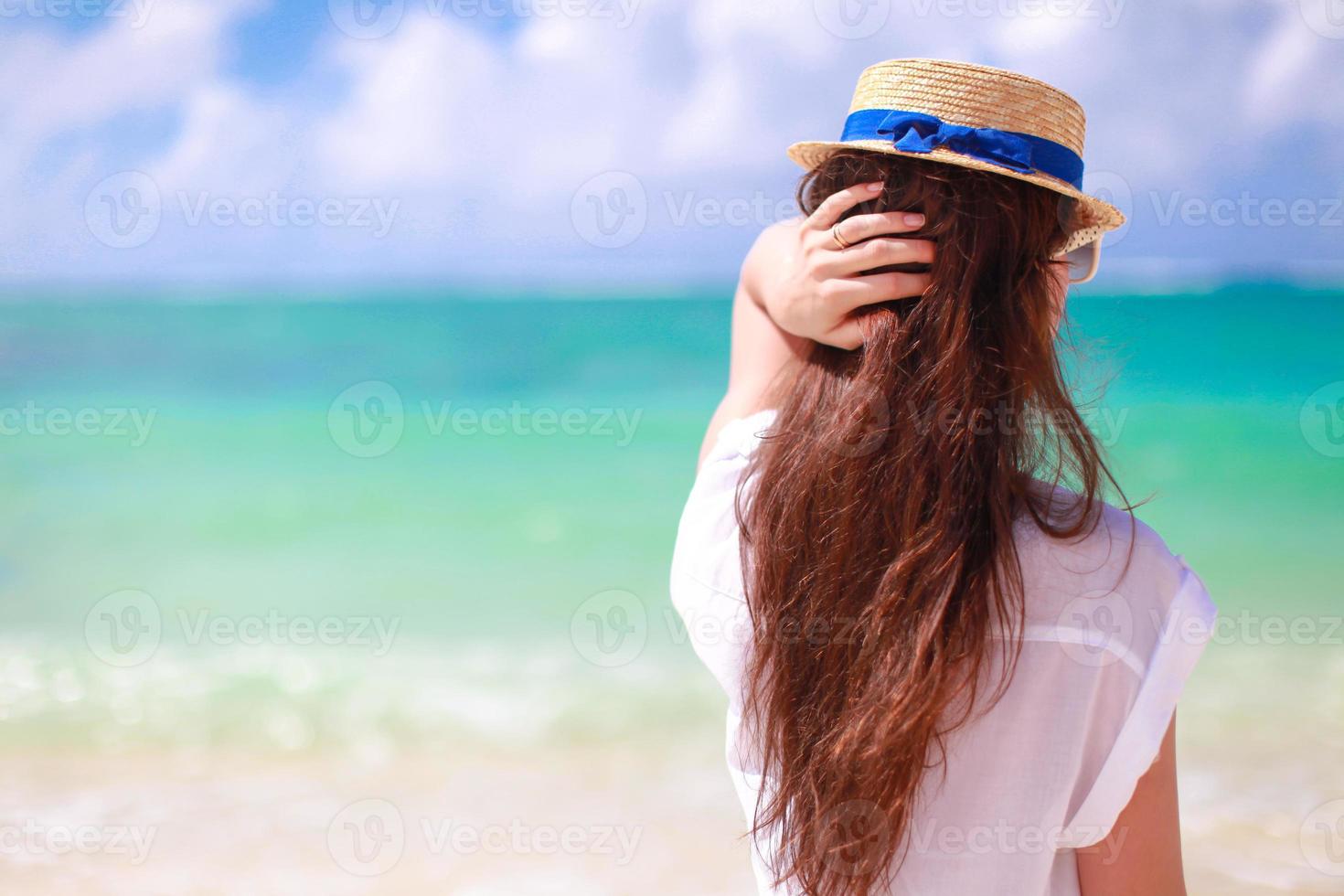 Back view of young woman during beach vacation photo