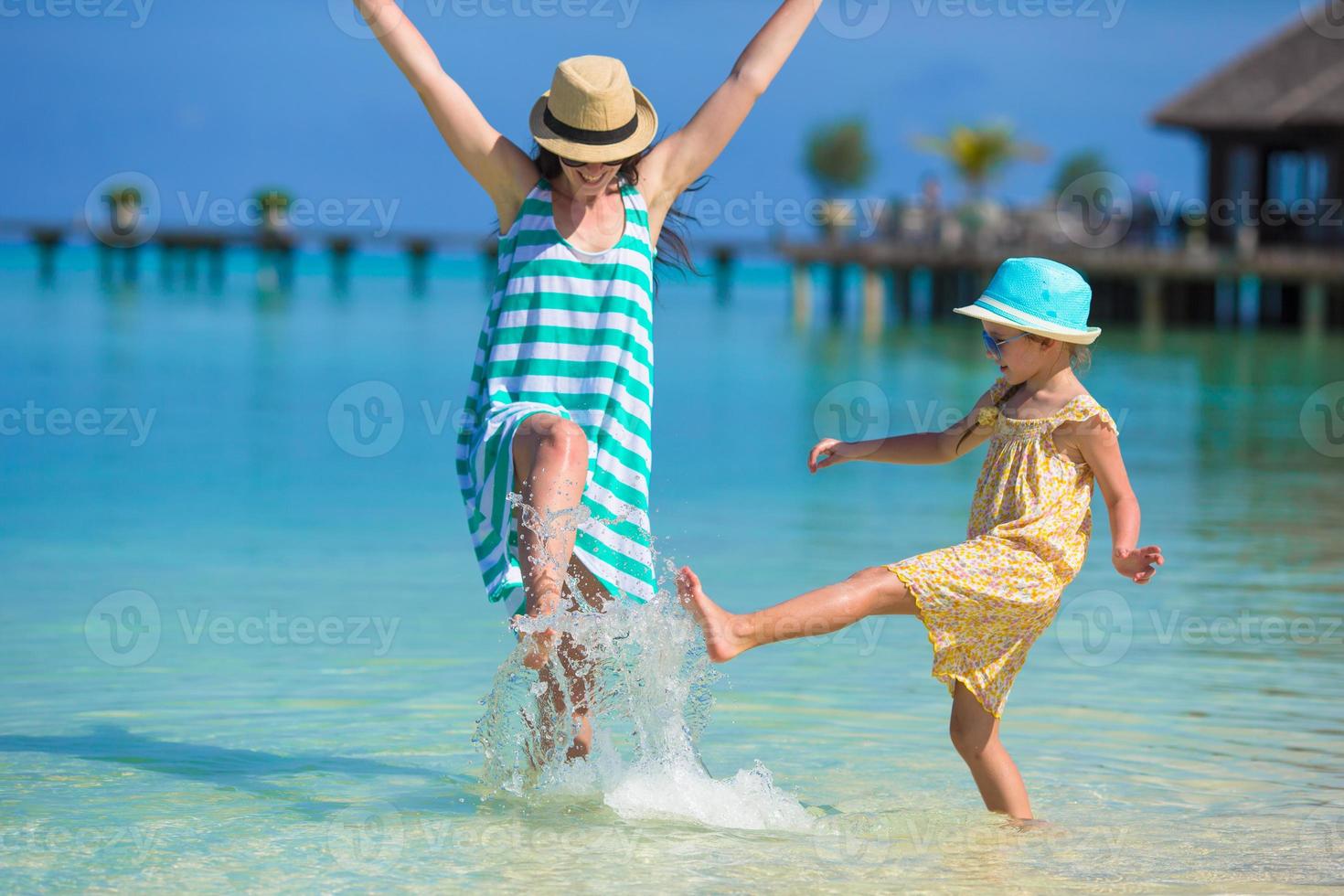 Mother and daughter enjoying time at tropical beach photo
