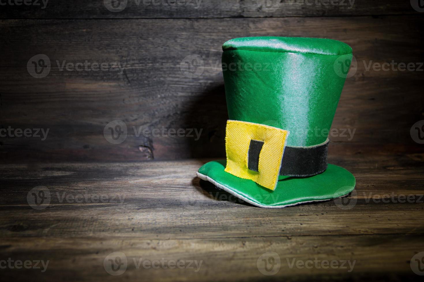 saint patricks day hat on rustic wood background photo