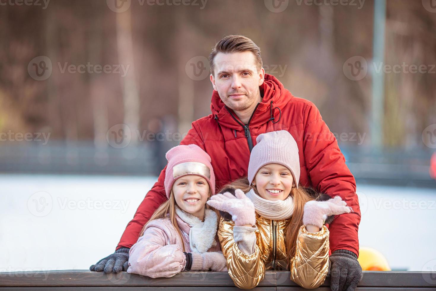 Family winter sport. Father and daughter on winter day photo