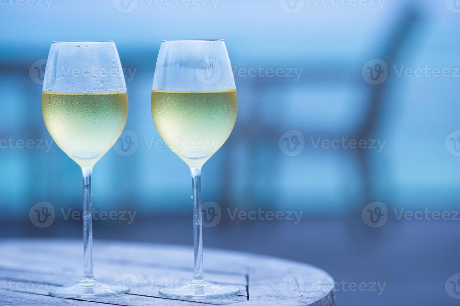 Two glasses of tasty white wine at sunset photo