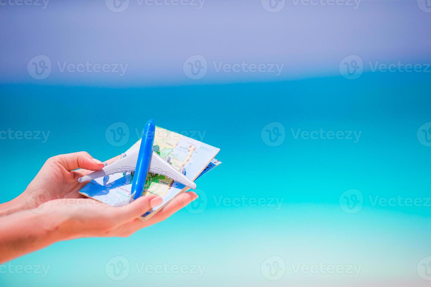 Closeup of map and toy airplane background the sea photo