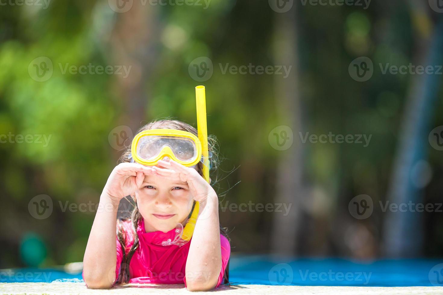 Adorable little girl in outdoor swimming pool photo