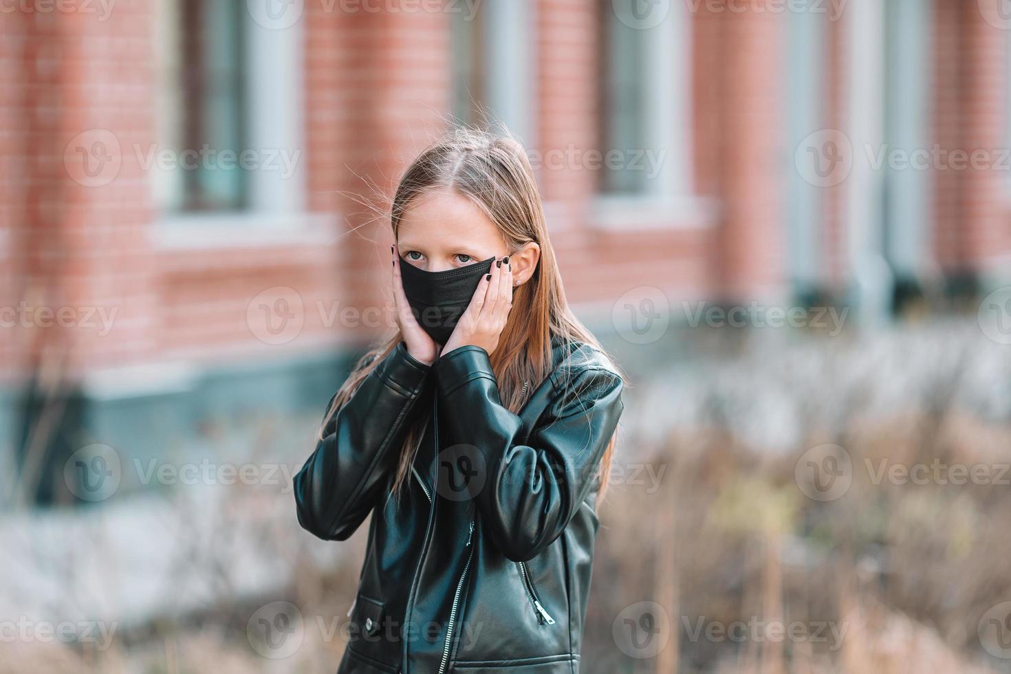 Girl wearing a mask on a background of a modern building, photo