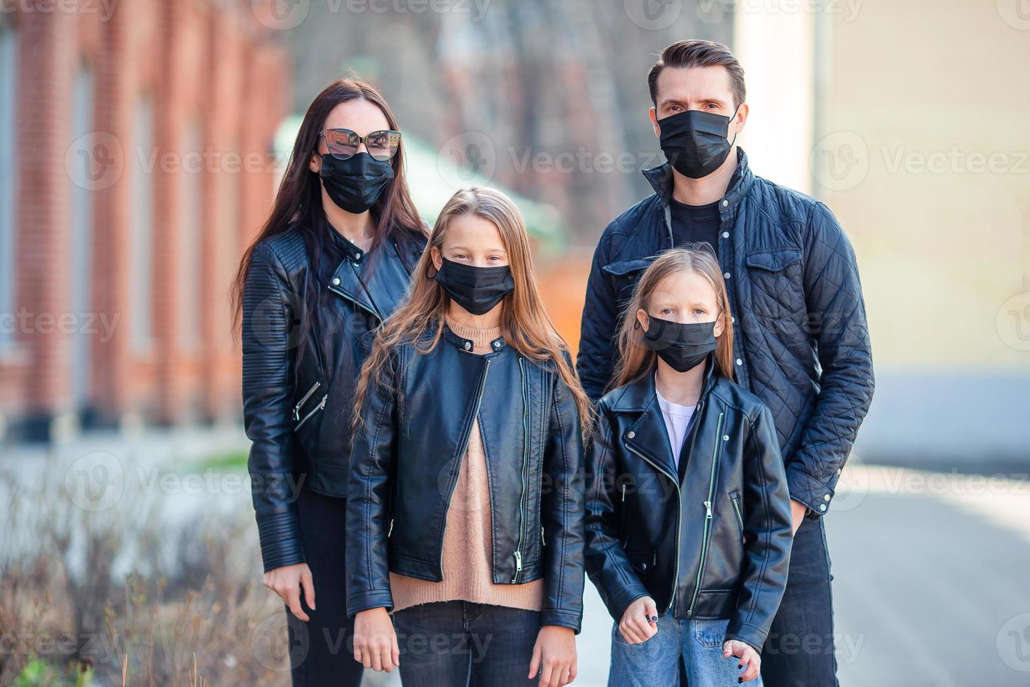 Family wearing masks to protect against Coronavirus and gripp photo