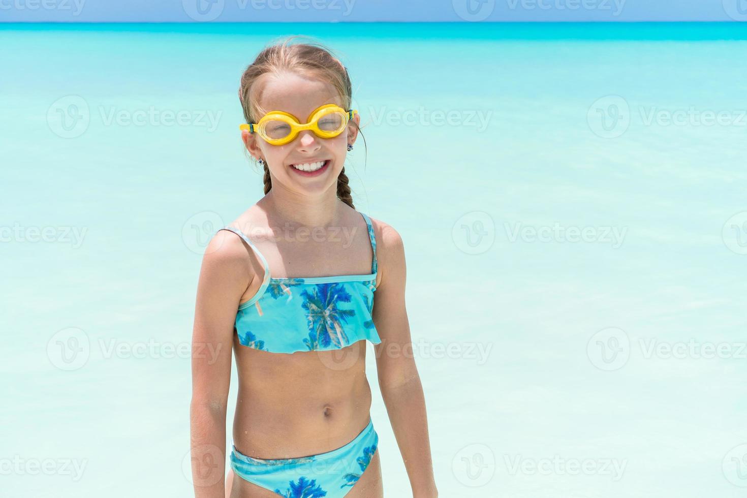 Cute little girl at beach during summer vacation photo
