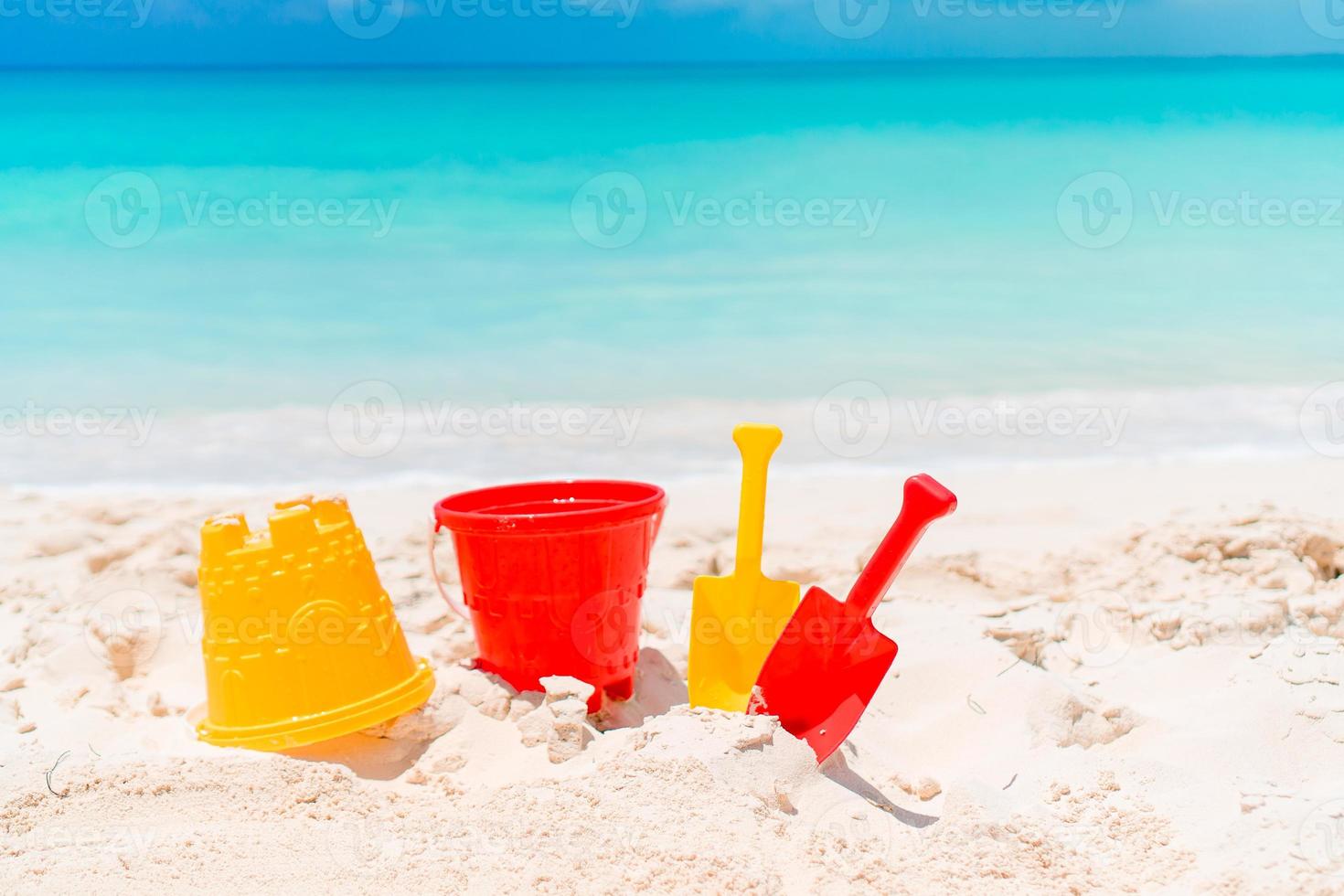 Beach kid's toys on white sand beach photo