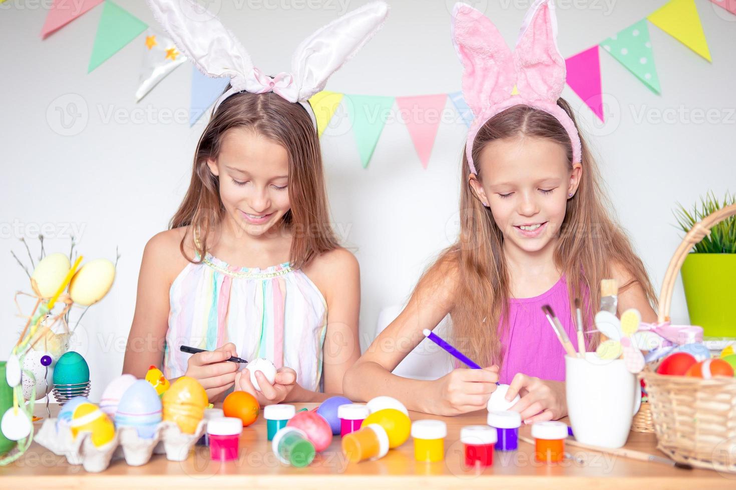 Happy easter. Beautiful little kids wearing bunny ears on Easter day. photo