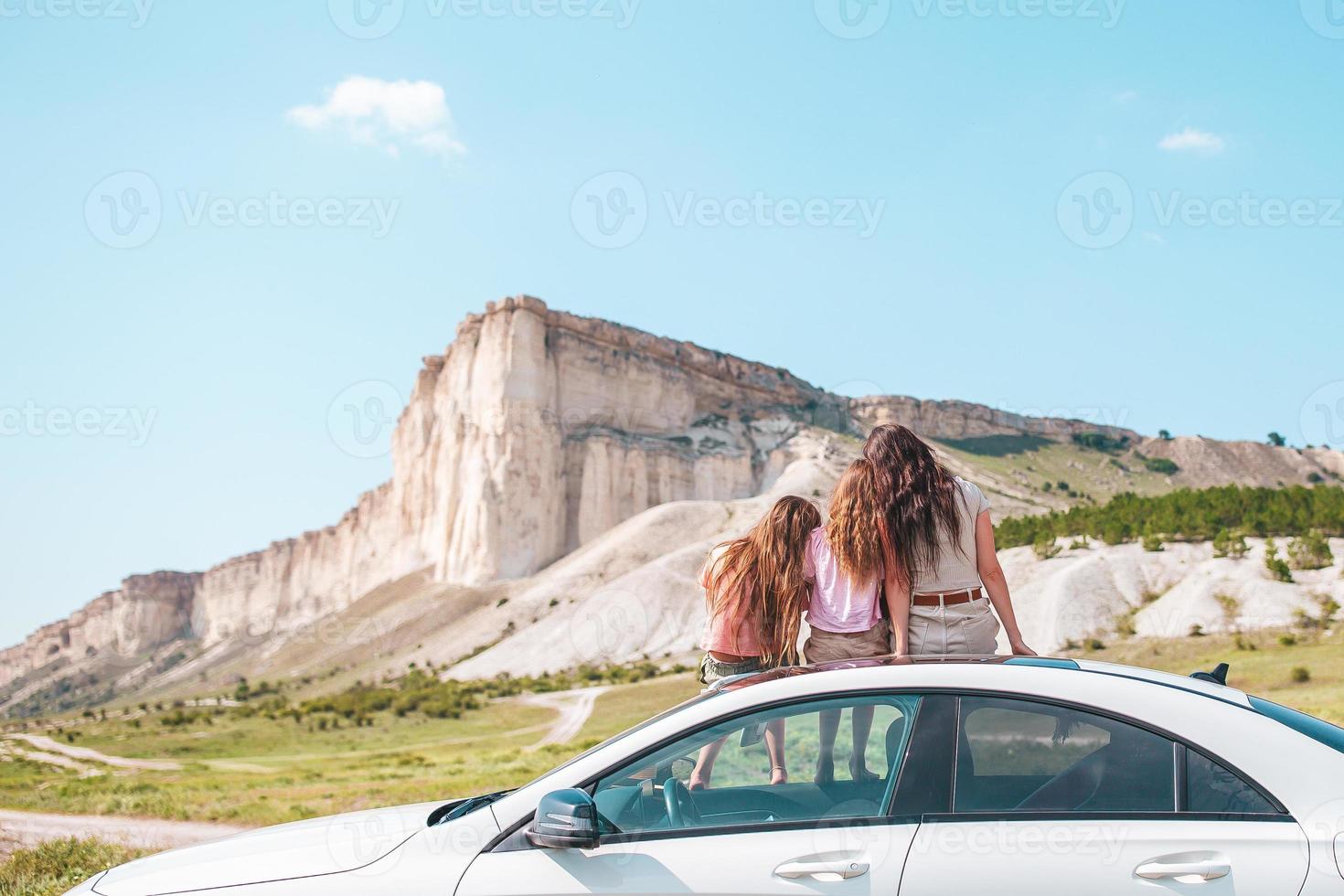 Happy family of three in the mountains photo