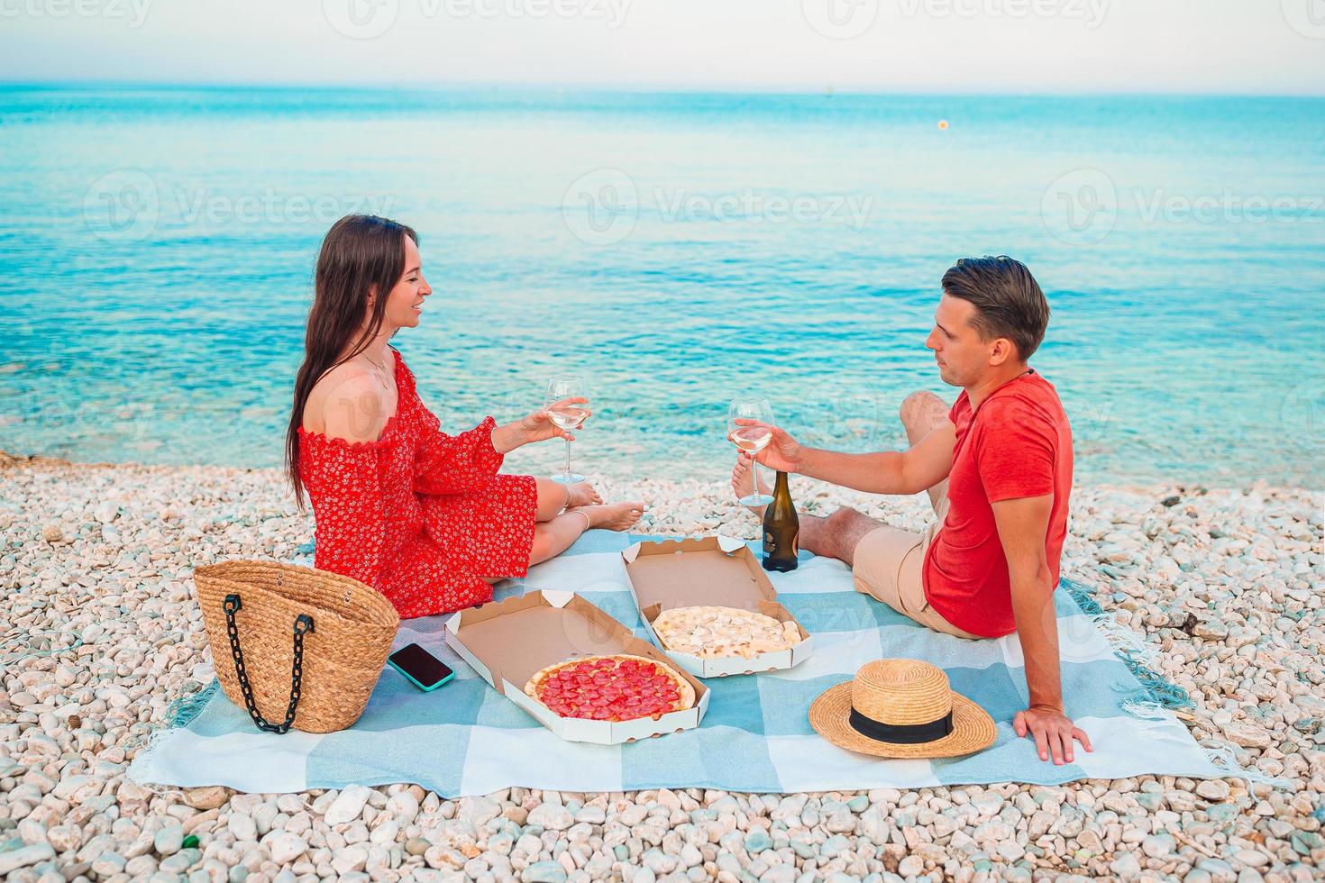 Family having a picnic on the beach photo