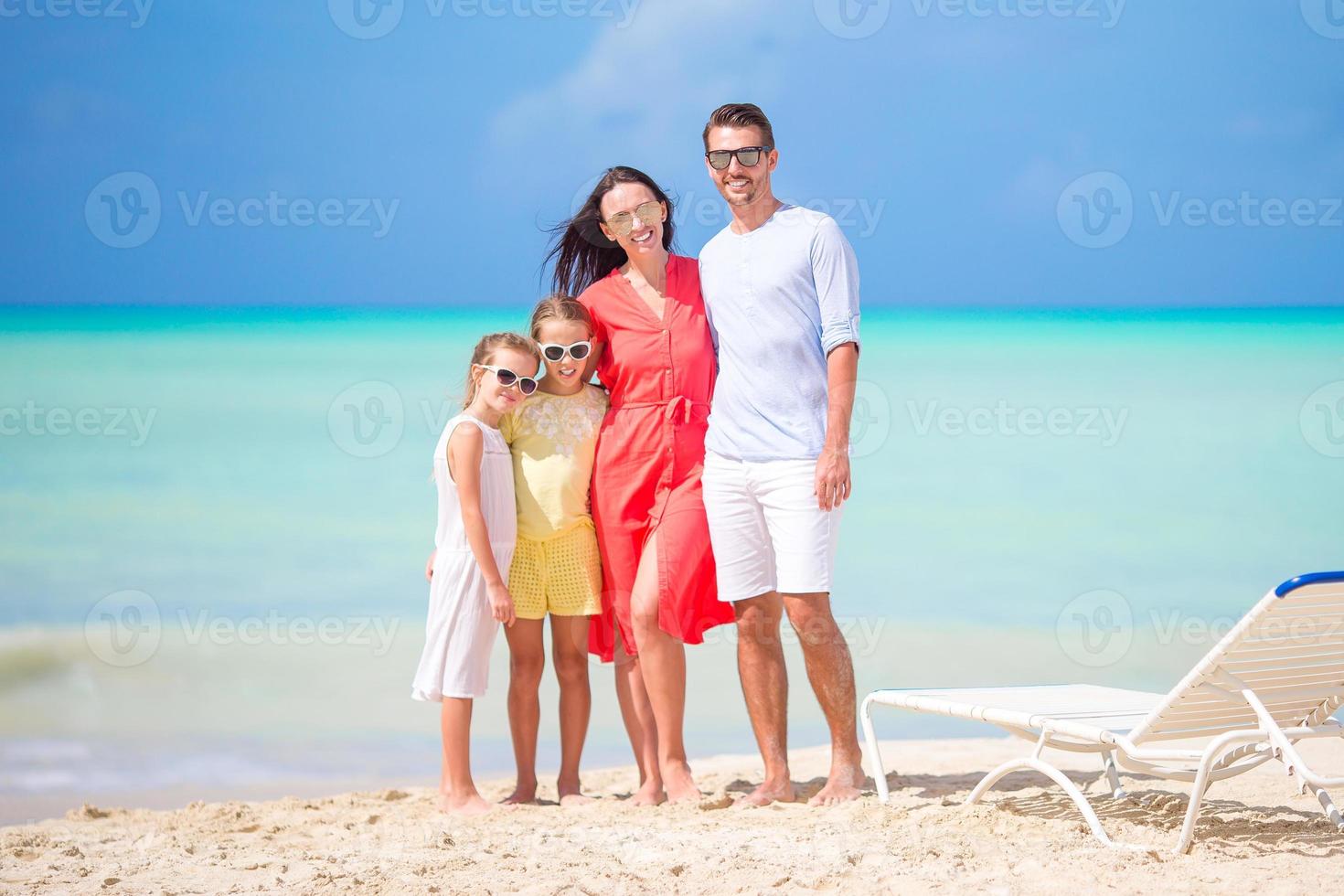Happy beautiful family on the beach photo
