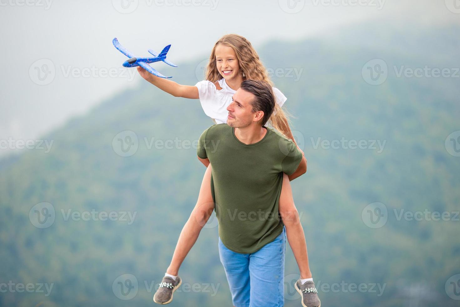 Beautiful happy family in mountains in the background of fog photo