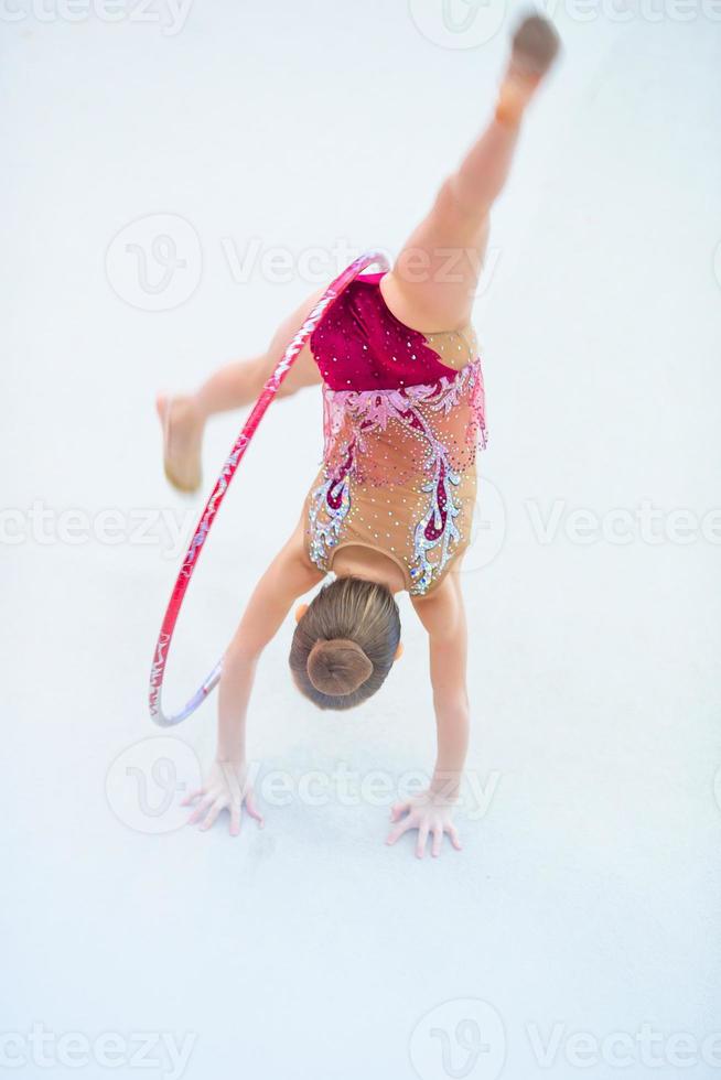 Little gymnast training on the carpet and ready for competitions photo