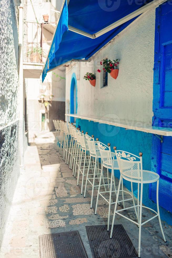 Summer empty outdoor cafe in a tourist place in Italy photo